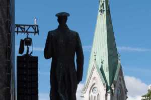 King Haakon VII statue in Wegelands Square and Cathedral tower, Kristiansand, Norway