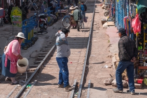 The PeruRail Titicaca train leaving Puno. The railtrack area utilized as market place for the local people after the train has passed