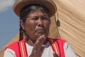 Indigenous Peruvian woman living among the Uru people on floating islands in Lake Titicaca near Puno Peru