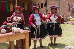 Indigenous Peruvian people in a small village in the Sacred Valley Peru. The community is processing wool to yarn and yarn to fabric, 3 of 7