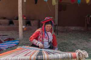 Indigenous Peruvian people in a small village in the Sacred Valley Peru. The community is processing wool to yarn and yarn to fabric, 5 of 7