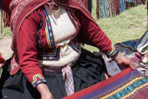 Indigenous Peruvian people in a small village in the Sacred Valley Peru. The community is processing wool to yarn and yarn to fabric, 6 of 7